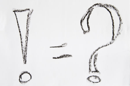 Hand-drawn question and exclamation marks, boldly marked in black on white sheet of paper, concept of questioning, uncertainty, searching for informationの写真素材