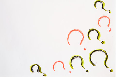 Hand-drawn question mark, boldly marked in black on white sheet of paper, symbolizing the concept of...