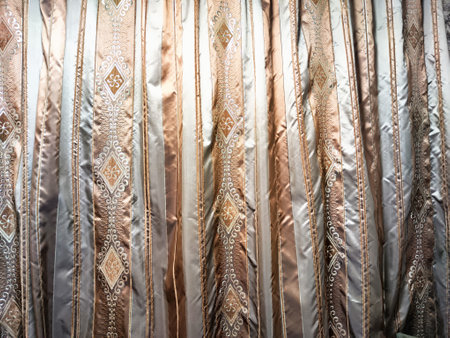 Close Up of a Striped Curtain in a Room. Detailed view of curtain with white and brown stripes,...