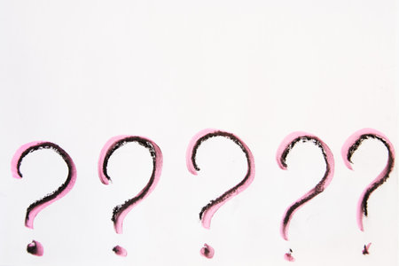 Hand-drawn question mark, boldly marked in black on white sheet of paper, symbolizing the concept of questioning, uncertainty, and the search for informationの写真素材