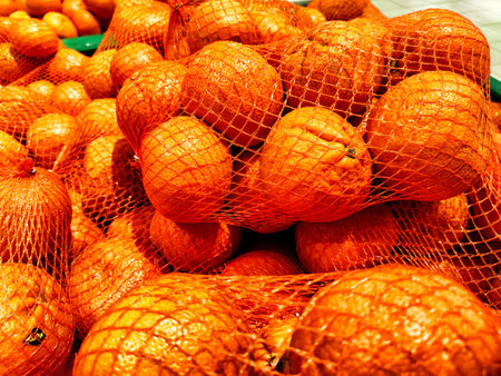 A Multitude of Fresh Oranges on Display at a Market Stall. Piles of vibrant oranges creating colorful texture in a marketの写真素材