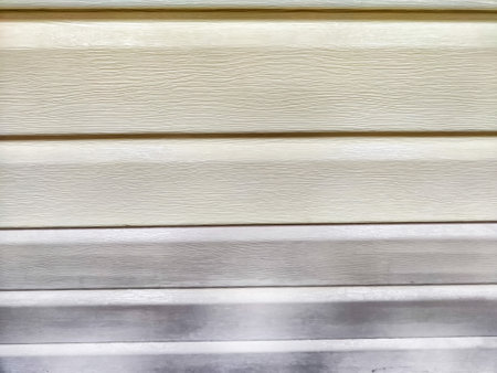 Close up of white vinyl siding with a wood grain texture. Background, texture, pattern, frame, copy space, place for textの写真素材