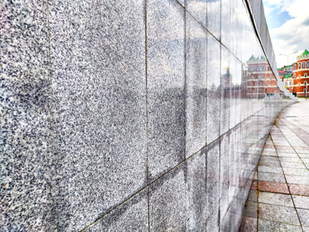 Granite tiles reflect historic buildings and cloudy skies in vibrant city center. Background, textureの写真素材