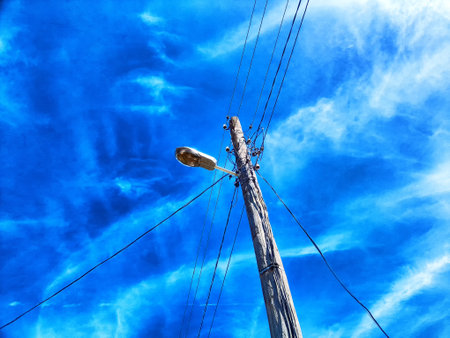 Old pole with wires against the sky. Electric transmission line, Eco-friendly energyの写真素材