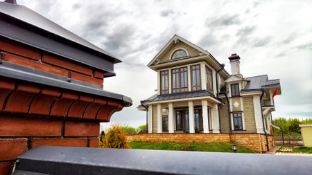 A grand mansion features a decorative gate and an overcast sky in the backgroundの写真素材