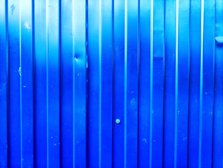 The vibrant blue background features vertical stripes and subtle texture, ideal for use as a backdrop with space for text and designs.の写真素材
