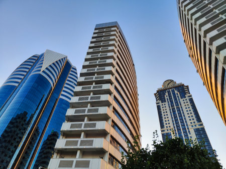 Modern skyscrapers in Grozny City rise high, reflecting the evening light under crisp blue skyの写真素材