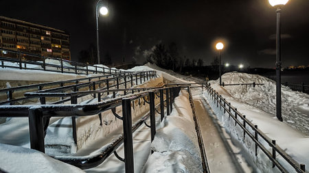 A wheelchair ramp struggles under the weight of snow, illustrating winter mobility issues in Russia for those with disabilitiesの写真素材