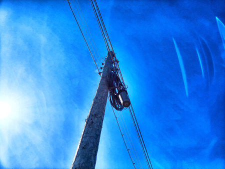 Old pole with wires against the sky. Electric transmission line, Eco-friendly energyの写真素材