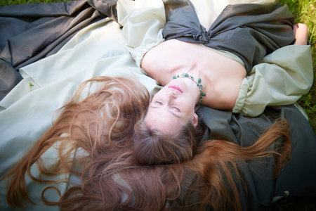 Beautiful dryad or fairy with gorgeous long hair in nature. Environmental friendliness and caring for nature. Adult mature woman 40-60 in Photo shootの写真素材