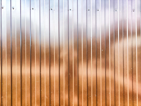 A textured metallic surface featuring vertical lines and a subtle blur that provides an ideal backdrop for adding text or graphics.の写真素材