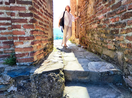 A traveler takes a selfie, enjoying the historic atmosphere of an ancient fortress in Georgia's...