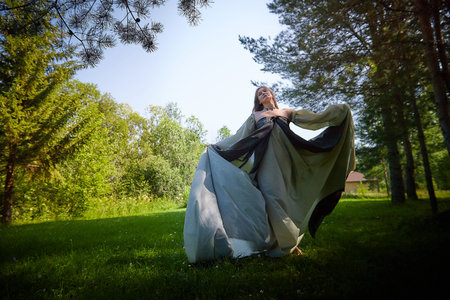 Beautiful dryad or fairy in nature. Pagan spirit of forest. Environmental friendliness and caring for nature. Adult mature woman 40-60 in Photo shootの写真素材