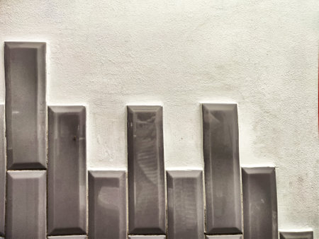 A contemporary wall showcases vertical patterns with smooth texture, providing space for text or design elementsの写真素材