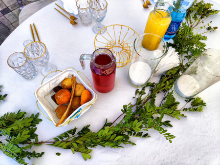 An inviting table hosts fresh fruits, refreshing drinks, and vibrant greenery, perfect for an afternoon gathering with friends.の写真素材