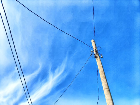 Old pole with wires against the sky. Electric transmission line, Eco-friendly energyの写真素材
