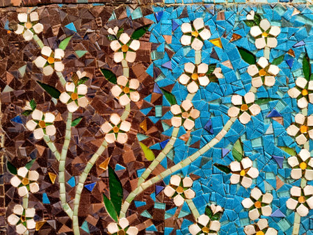 This artwork showcases beautiful floral patterns made from colorful tiles, blending rich earthy tones with vibrant blues.の写真素材