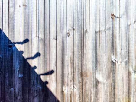 Old wooden fence with shadow. Abstract background and texture for design.の写真素材