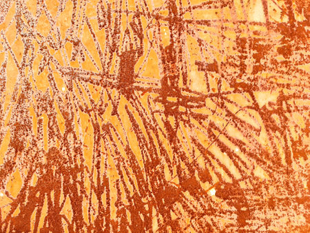 The image features an intricate texture with orange and brown layers, creating abstract patterns...
