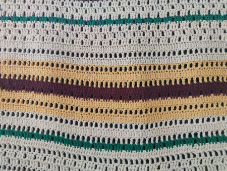 This vibrant crochet pattern diverse features stripes in various colors and textures ideal for textile projects or home dの写真素材