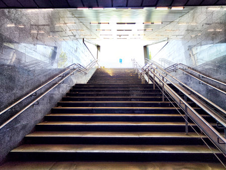 A stunning staircase gracefully ascends, beautifully illuminated by warm sunlight and encircled by...
