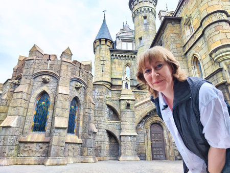 A woman enjoys her travel adventure at Garibaldi Castle, showcasing her excitement in a historic...