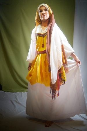 Rebekah in traditional eastern attire, standing gracefully with a flowing garment during a biblical-themed photoshootの写真素材