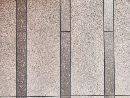 Light gray textured tiles create a seamless background with clear areas for text or graphics,...