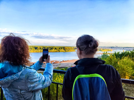 Visitors enjoy taking photos of the beautiful river landscape while standing on a viewing platform...