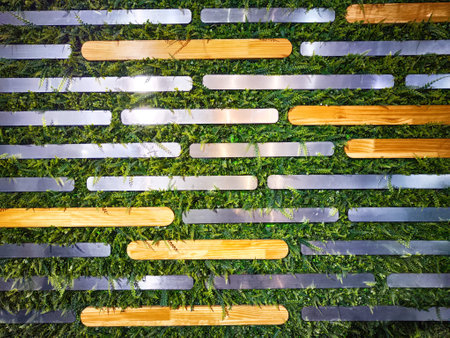 Unique wall decor combines wooden strips and greenery to enhance creative environments with a fresh, modern aesthetic.の写真素材