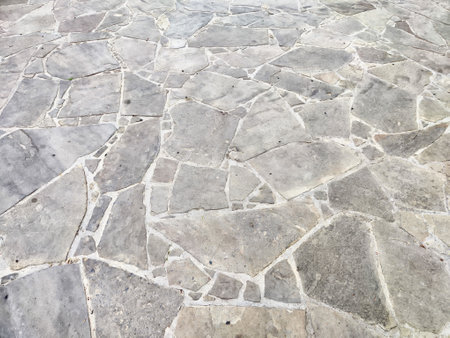 A beautifully arranged outdoor surface shows a pattern of irregularly shaped stone tiles, suitable...