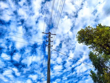 Old pole with wires against the sky. Electric transmission line, Eco-friendly energyの写真素材