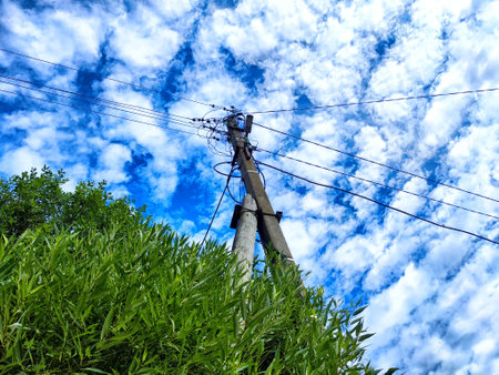 Old pole with wires against the sky. Electric transmission line, Eco-friendly energyの写真素材
