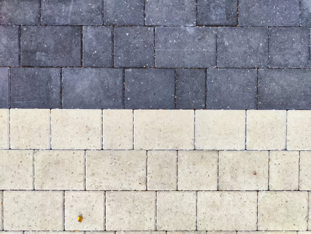 A patterned walkway features alternating dark and light pavers arranged neatly.