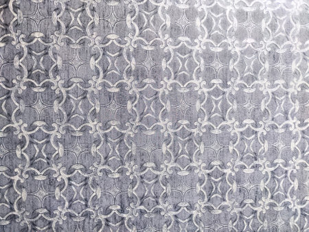 Decorative gray background features an intricate repeating pattern, offering an ideal area for...