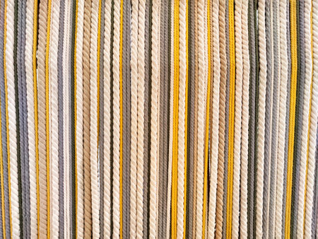 Stripes of textured fabric in soft neutral tones create a versatile background that integrates...