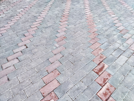 A patterned arrangement of paving stones creates a visually striking effect in a driveway.の写真素材