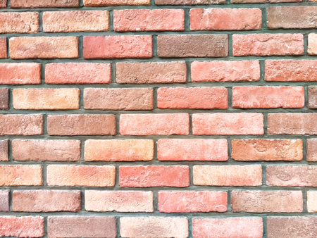 This rustic brick wall features warm tones and a textured surface, providing a versatile backdrop...