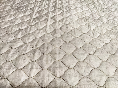 This quilted texture features a delicate pattern, perfect for enhancing backgrounds or crafting...
