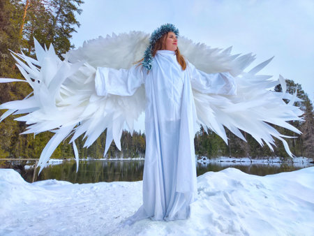 Girls in white dresses gracefully pose by a serene lake during a winter-themed role-playing photoshoot at the changing seasonの写真素材