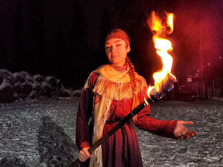Fire performance showcases Viking warriors in ethnic costumes on a cold winter night