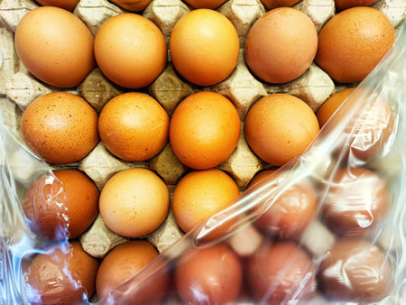 Brown eggs neatly arranged in carton trays, prepared for transportation from the farm to local shops...