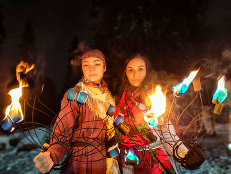 Captivating fire show featuring actors in ethnic costumes on a frosty winter night