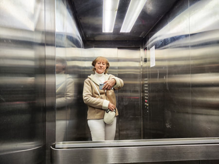 Woman takes a casual selfie in an elevator, capturing her travel adventure and lifestyle while...