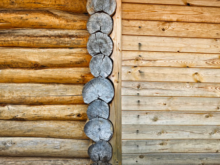 Close-up view of log cabin wall features wooden beams and textures, displaying craftsmanship in natural materials and design.の写真素材
