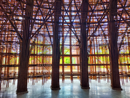Intricate bamboo frame showcases stunning architecture amidst lush greenery on a bright day, emphasizing natural materials.の写真素材