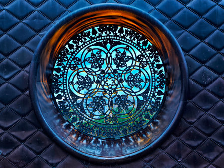 A beautifully crafted circular pattern glows with soft light, showing detailed designs in a decorative architectural space.の写真素材