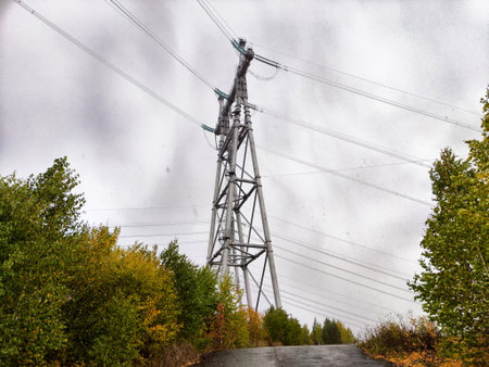 Transmission tower of Krasnoyarsk hydroelectric power station stands amidst colorful trees on a...