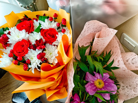 Brightly colored flower arrangements are beautifully wrapped, showing a mix of cheerful blooms perfect for a special occasion or celebration.の写真素材
