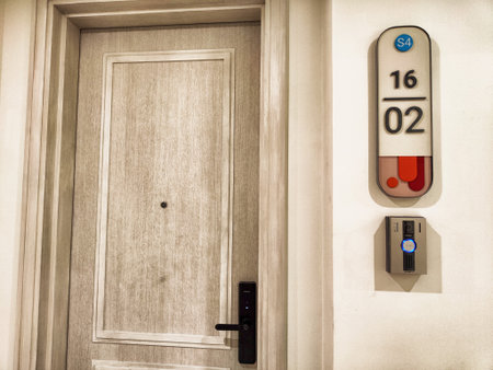 Modern hotel room 1602 features a stylish door with digital access technology, exemplifying contemporary design and convenience for guests.の写真素材